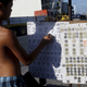 A teenager places bets on a numbers game along a road in San Fernando city, north of Manila.
